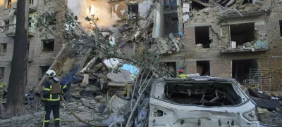 Firefighters work in a destroyed apartment building after a Russian attack in Kyiv, Ukraine, early Monday, June 23, 2025. (AP Photo/Efrem Lukatsky)