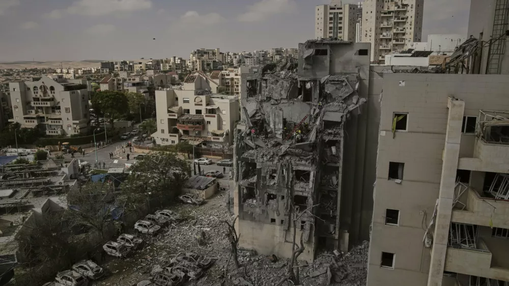 Israeli soldiers and rescue team work amid the rubble of residential buildings destroyed by an Iranian missile strike that killed several people, in Beersheba, Israel, on Tuesday, June 24, 2025. (AP Photo/Leo Correa)