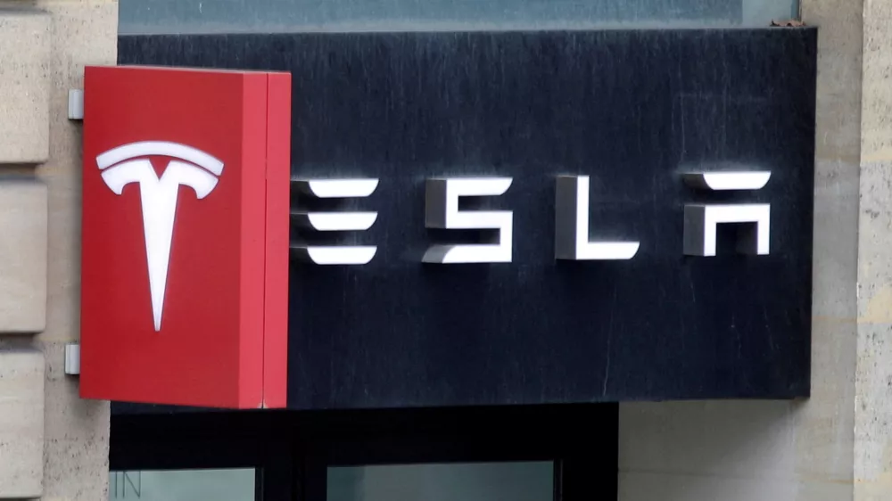 FILE PHOTO: The logo of Tesla is seen on a store in Paris, France, October 30, 2020. REUTERS/Charles Platiau/File Photo