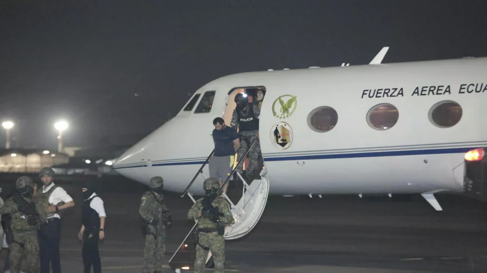 Escorted by soldiers and policemen, Adolfo "Fito" Macias, the leader of the Choneros gang, arrives in Guayaquil, Ecuador, Wednesday, June 25, 2025. (AP Photo/Joffre Flores)