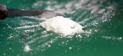 FILED - 24 February 2022, Hamburg: A press spokesman for Hamburg customs presents a small part of a seized cocaine find at a media event in the port in 2022. Photo: Marcus Brandt/dpa