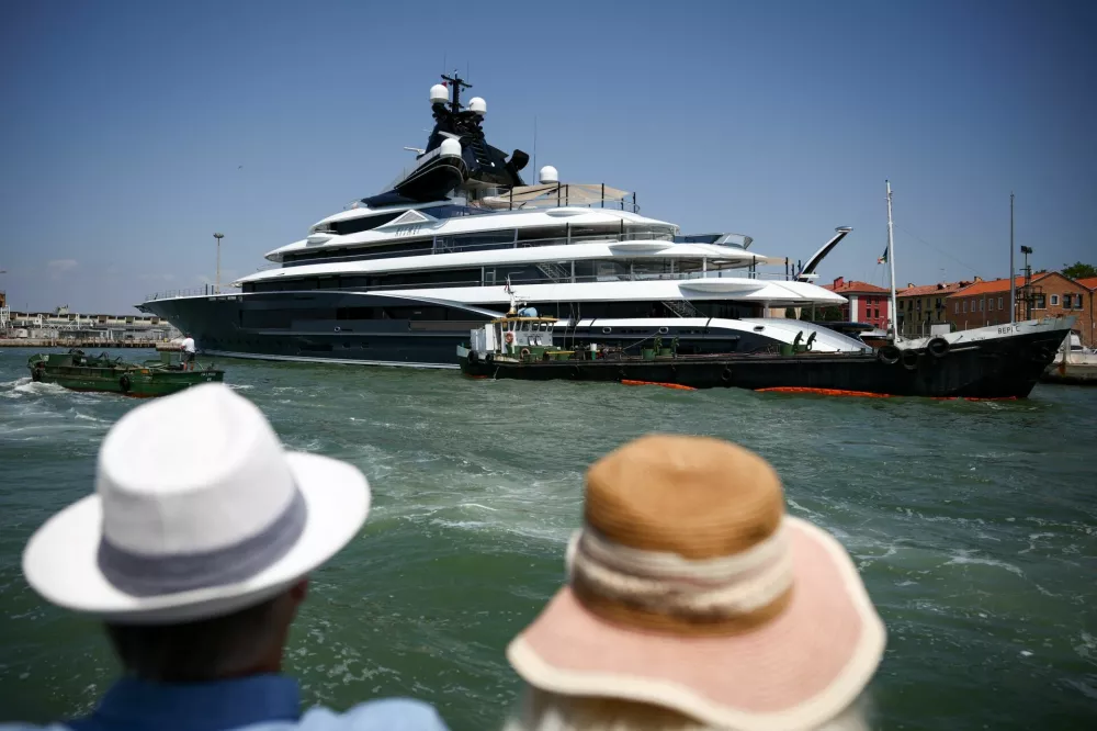 People look at the super yacht Kismet ahead of the expected wedding of Amazon founder Jeff Bezos and Lauren Sanchez, in Venice, Italy, June 24, 2025. REUTERS/Guglielmo Mangiapane