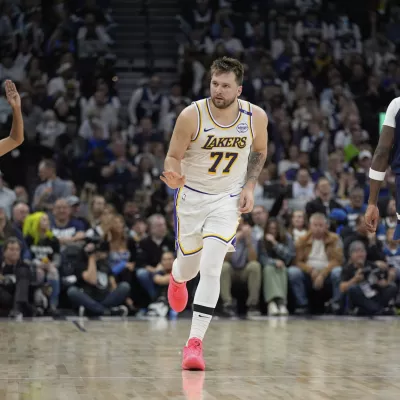 Los Angeles Lakers guard Luka Doncic (77) gestures after making a 3-point basket during the first half of Game 4 of an NBA basketball first-round playoff series against the Minnesota Timberwolves, Sunday, April 27, 2025, in Minneapolis. (AP Photo/Abbie Parr)