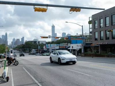 FILE PHOTO: A Tesla robotaxi drives on the street along South Congress Avenue in Austin, Texas, U.S., June 22, 2025. REUTERS/Joel Angel Juarez/File Photo