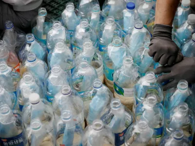 FILE PHOTO: Members of North Korean defector group Kuensaem fill empty plastic bottles with rice and masks, during preparations for an event to send the bottles towards the North, in Seoul, South Korea, June 18, 2020. REUTERS/Kim Hong-Ji/File Photo