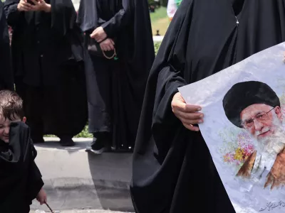A woman holds a picture of Iran's Supreme Leader Ayatollah Ali Khamenei as she attends the funeral procession of Iranian military commanders and nuclear scientists killed in Israeli strikes, in Tehran, Iran, June 28, 2025. Majid Asgaripour/WANA (West Asia News Agency) via REUTERS  ATTENTION EDITORS - THIS PICTURE WAS PROVIDED BY A THIRD PARTY