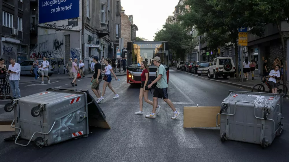 People walk past barricades during road blockades organised by students and anti-government demonstrators demanding snap elections and release of detained protestors, in Belgrade, Serbia, June 30, 2025. REUTERS/Marko Djurica