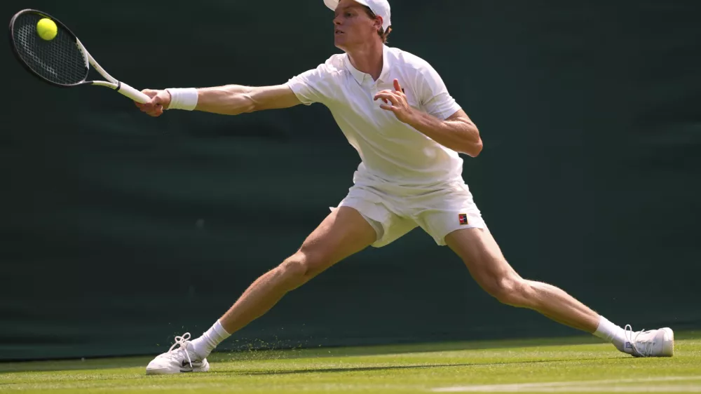 Jannik Sinner of Italy plays a return to Luca Nardi of Italy during their first round men's singles match at the Wimbledon Tennis Championships in London, Tuesday, July 1, 2025.(AP Photo/Kirsty Wigglesworth)