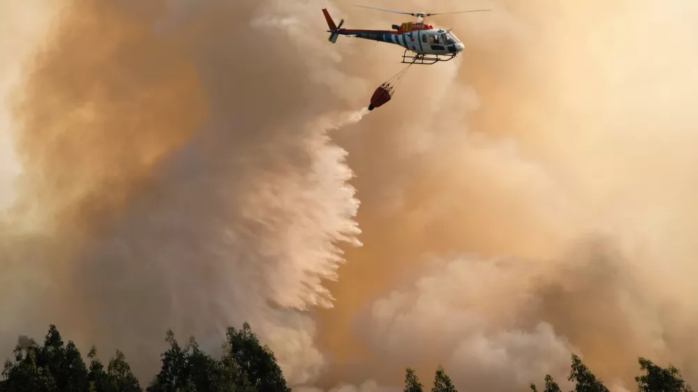 ﻿A firefighting helicopter drops its load of water on a forest fire near Santa Comba Dao, northern Portugal, Thursday, Aug. 11 2016. Firefighters in Portugal are battling multiple blazes fed by brush in a hot, dry summer for a sixth straight day. Major fires have also been raging in northwestern Spain and southern France. (AP Photo/Sergio Azenha)