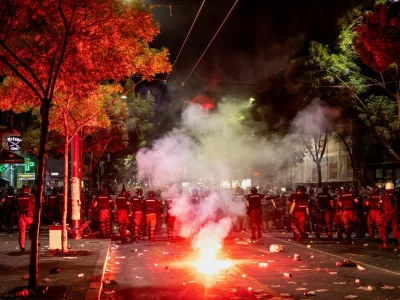 Law enforcement officers take position as a fire burns nearby during an anti-government protest demanding snap elections, in Belgrade, Serbia, June 28, 2025. REUTERS/Marko Djurica
