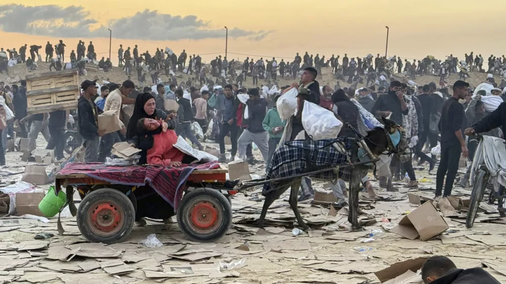 This photo, provided by an American contractor on condition of anonymity because they were revealing their employers' internal operations, shows a woman slumped over in a donkey cart after the contractor said she was hit in the head with part of a stun grenade at a food distribution site in Gaza run by the Gaza Humanitarian Foundation in June 2025. (AP Photo)
