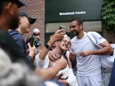 Tennis - Wimbledon - All England Lawn Tennis and Croquet Club, London, Britain - July 5, 2025 Croatia's Marin Cilic with fans as he leaves the court after winning his third round match against Spain's Jaume Munar REUTERS/Isabel Infantes