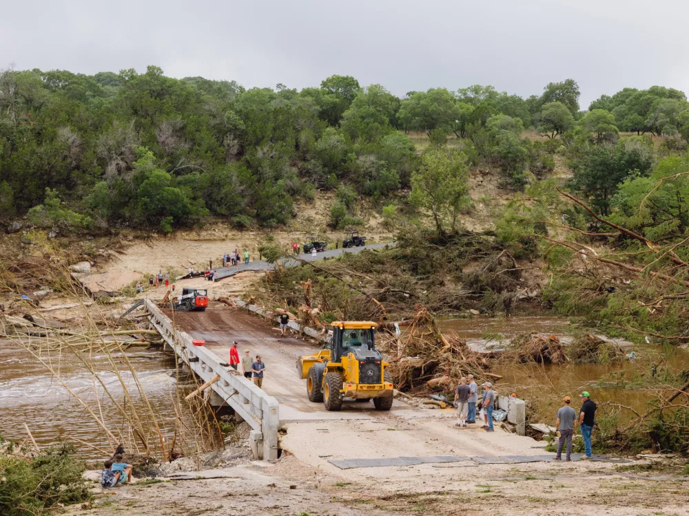 05 July 2025, US, IngramConstruction workers start to clear and temporarily repair a bridge connecting TX 39 to a residential area over the Guadalupe River in Ingram. PhotoSan Antonio Express-News/Express-News via ZUMA Press Wire/dpa