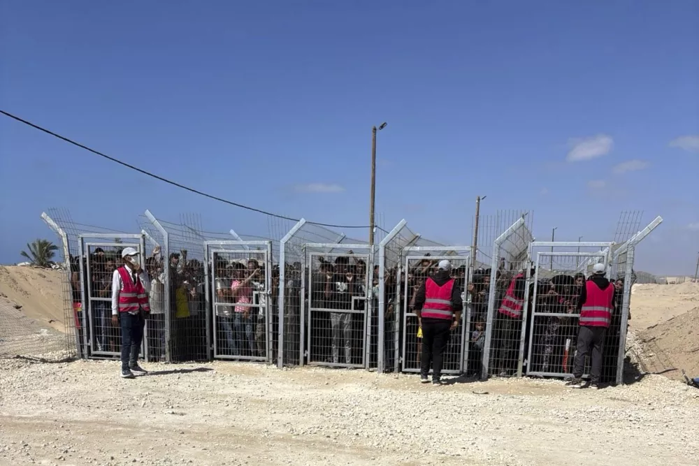 This photo, provided by an American contractor on condition of anonymity, shows Palestinians behind gates before entering a food distribution site operated by the Gaza Humanitarian Foundation in May 2025, shortly after the start of the organization's distribution sites. (AP Photo)