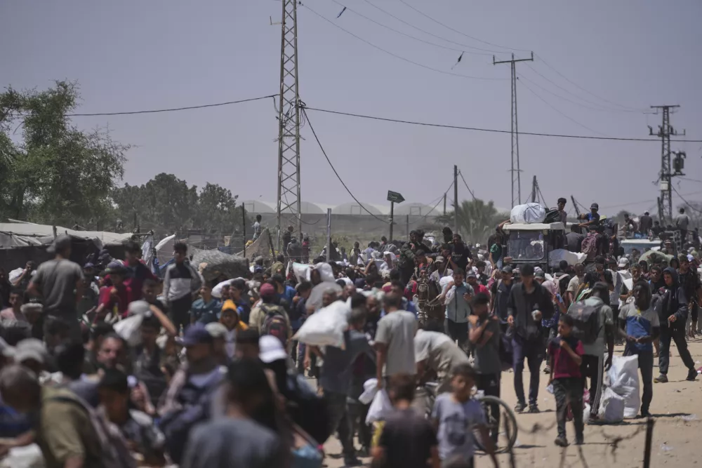 Palestinians carry bags containing food and humanitarian aid packages delivered by the Gaza Humanitarian Foundation, a U.S.-backed organization, in Rafah, southern Gaza Strip, Monday, June 16, 2025. (AP Photo/Abdel Kareem Hana)