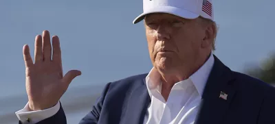 President Donald Trump waves to the media after exiting Air Force One, at Joint Base Andrews, Md., Sunday, July 6, 2025, en route to the White House after spending the weekend in New Jersey. (AP Photo/Jacquelyn Martin)