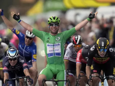Britain's Mark Cavendish, wearing the best sprinter's green jersey, celebrates with teammate in background Denmark's Michael Morkov, as he crosses the finish line to win the tenth stage of the Tour de France cycling race over 190.7 kilometers (118.5 miles) with start in Albertville and finish in Valence, France, Tuesday, July 6, 2021. (AP Photo/Daniel Cole)