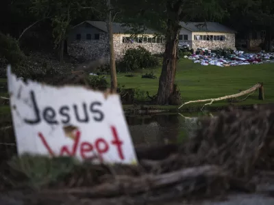Camper's belongings sit outside one of Camp Mystic's cabins near the Guadalupe River, Monday, July 7, 2025, in Hunt, Texas, after a flash flood swept through the area. (AP Photo/Eli Hartman)