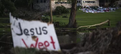 Camper's belongings sit outside one of Camp Mystic's cabins near the Guadalupe River, Monday, July 7, 2025, in Hunt, Texas, after a flash flood swept through the area. (AP Photo/Eli Hartman)