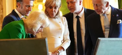 King Charles III and Queen Camilla with the President of France Emmanuel Macron and his wife Brigitte Macron view items on display during a visit to the Royal Collection exhibition, in the Green Drawing Room at Windsor Castle, Berkshire, on day one of the French President's state visit to the UK. Picture date: Tuesday July 8, 2025.  Aaron Chown/Pool via REUTERS