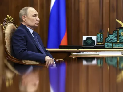 Russian President Vladimir Putin listens to Archpriest Alexander Tkachenko, Chairman of the Board of the Circle of Kindness Foundation and head of the commission for social partnership, trusteeship, and inclusive practices at the Russian Civic Chamber, at the Kremlin in Moscow, on Friday, May 30, 2025. (Alexander Kazakov, Sputnik, Kremlin Pool Photo via AP)