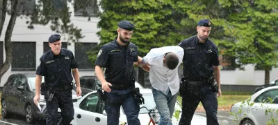 Emanuel Rep v spremstvu policistov na zaslišanje v Varaždinu. Sumijo ga umora mame s sekiro ter poskusa umorov polbrata in očima. 