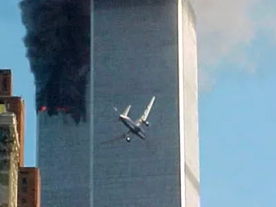 ﻿** ADVANCE FOR TUESDAY, NOV. 4, 2008 AND THEREAFTER ** FILE ** In this Sept. 11, 2001 file photo, a jet airliner nears one of the World Trade Center towers in New York. For all of the candidates' talk about the need for change, Americans have seen plenty of it since the last time they selected a new leader - including the attack on the World trade Center in 2001. (AP Photo/Carmen Taylor/File)