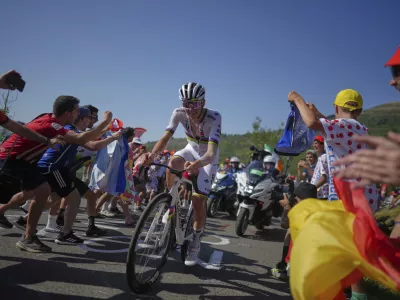 Slovenia's Tadej Pogacar climbs towards Hautacom to win the twelfth stage of the Tour de France cycling race over 180.6 kilometers (112.2 miles) with start in Auch and finish in Hautacam, France, Thursday, July 17, 2025. (AP Photo/Thibault Camus)