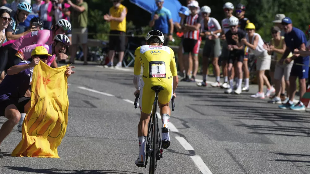 Slovenia's Tadej Pogacar, wearing the overall leader's yellow jersey, climbs during the thirteenth stage of the Tour de France cycling race, an individual time-trial over 10.5 kilometers (6.5 miles) in the Pyrenees mountains with start in Loudenvielle and finish in Peyragudes, France, Friday, July 18, 2025. (AP Photo/Mosa'ab Elshamy)