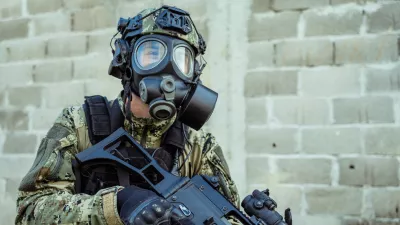 Soldier in cropat uniform with protective gas mask M95 and assault rifle G36, caliber 5.56x45.