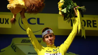 Cycling - Tour de France - Stage 9 - Chinon to Chateauroux - Chinon, France - July 13, 2025 UAE Team Emirates XRG's Tadej Pogacar celebrates on the podium wearing the yellow jersey after stage 9 REUTERS/Sarah Meyssonnier