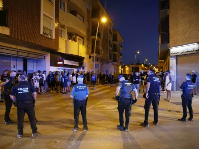 Local police officers and Spanish civil guard agents take positions during the disturbances in Torre Pacheco, eastern Spain, Friday, July 12, 2025. (Martín C./Europa Press via AP)