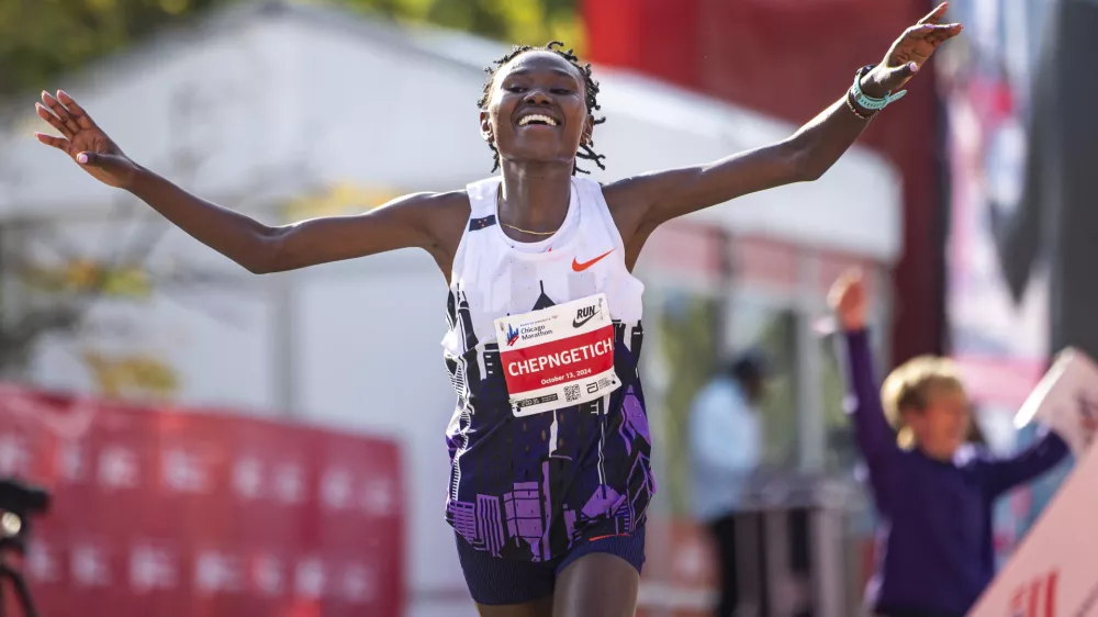 FILE - Ruth Chepngetich, from Kenya, crosses the finish line of the Chicago Marathon to win the women's professional division and break the women's marathon world record in Grant Park on Oct. 13, 2024. (Tess Crowley/Chicago Tribune via AP, file)