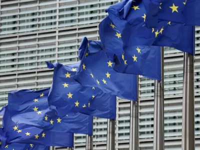 European Union flags flutter outside the EU Commission headquarters, on the day farmers protest against proposed cuts to Common Agricultural Policy (CAP) funding and the European Commission's plan to merge agricultural and cohesion policies, in Brussels, Belgium July 16, 2025. REUTERS/Yves Herman