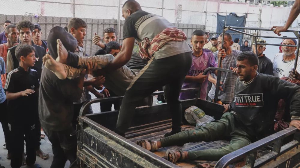 Palestinians who were injured during a food distribution at a center run by the Gaza Humanitarian Foundation, a U.S.-backed organization approved by Israel, are brought to Nasser Hospital in Khan Younis, southern Gaza Strip, Saturday, July 19, 2025. (AP Photo/Mariam Dagga)