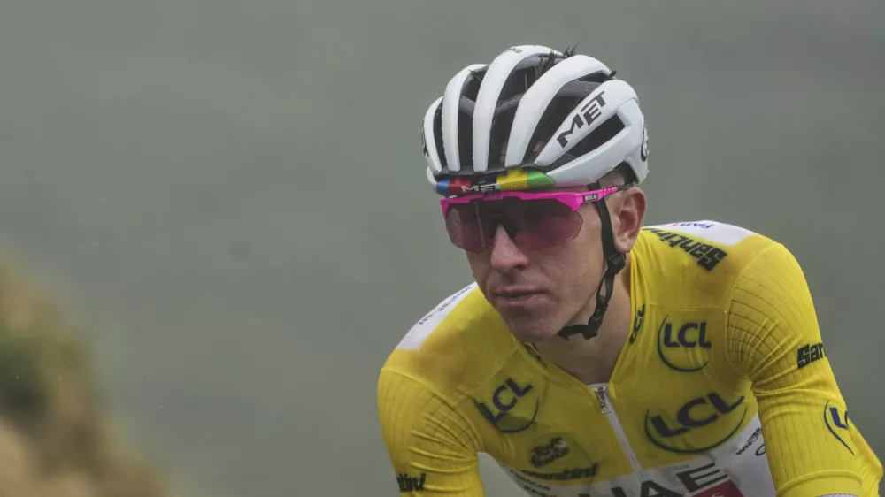 Slovenia's Tadej Pogacar, wearing the overall leader's yellow jersey, speeds down Aspin pass during the fourteenth stage of the Tour de France cycling race over 182.6 kilometers (113.5 miles) with start in Pau and finish in Luchon Superbagneres, France, Saturday, July 19, 2025. (AP Photo/Thibault Camus)