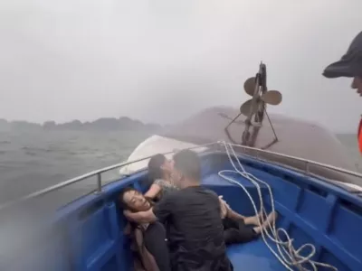 This image from a video provided by QDND shows people on a rescue boat after their tourist boat capsized in Ha Long Bay, Vietnam on Saturday, July 19, 2025. (QDND via AP)
