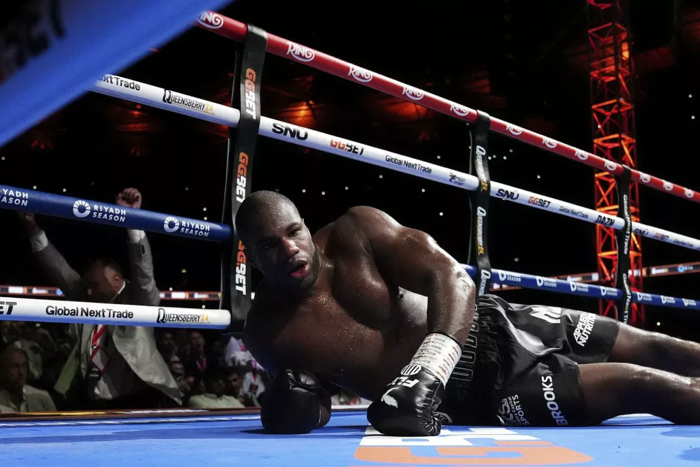 Daniel Dubois lies on the ring after a knockout by Ukraine's Oleksandr Usyk during their world heavyweight boxing title fight, in London, Saturday, July 19, 2025. (Bradley Collyer/PA via AP)