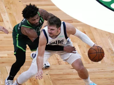 ﻿Dallas Mavericks guard Luka Doncic, right, is pressured by Boston Celtics guard Marcus Smart during the second half of an NBA basketball game Wednesday, March 31, 2021, in Boston. (AP Photo/Charles Krupa)