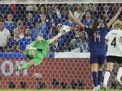 Germany goalkeeper Ann-Katrin Berger makes a save during the Women's Euro 2025 quarterfinals soccer match between France and Germany at St. Jakob-Park in Basel, Switzerland, Saturday, July 19, 2025. (AP Photo/Alessandra Tarantino)