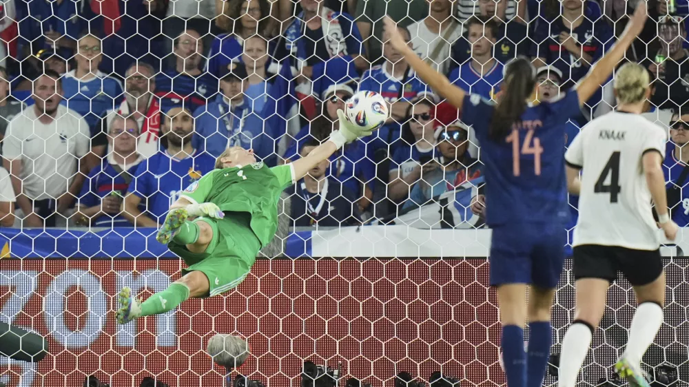 Germany goalkeeper Ann-Katrin Berger makes a save during the Women's Euro 2025 quarterfinals soccer match between France and Germany at St. Jakob-Park in Basel, Switzerland, Saturday, July 19, 2025. (AP Photo/Alessandra Tarantino)