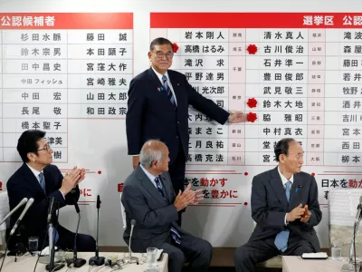 Shigeru Ishiba, Japanese Prime Minister and president of the ruling Liberal Democratic Party (LDP), places a red paper rose on the name of an elected candidate at the LDP headquarters, on the day of Upper House election, in Tokyo, Japan July 20, 2025.  Franck Robichon/Pool via REUTERS