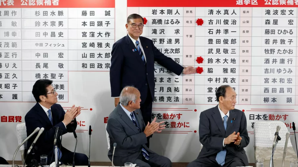 Shigeru Ishiba, Japanese Prime Minister and president of the ruling Liberal Democratic Party (LDP), places a red paper rose on the name of an elected candidate at the LDP headquarters, on the day of Upper House election, in Tokyo, Japan July 20, 2025.  Franck Robichon/Pool via REUTERS