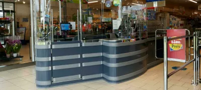 2R4E16R Uelsen, Germany May 16 2023 An unused checkout desk at the Lidl. The cashieres are protected against viruses by large plastic walls since covidFoto: Reuters/Alamy