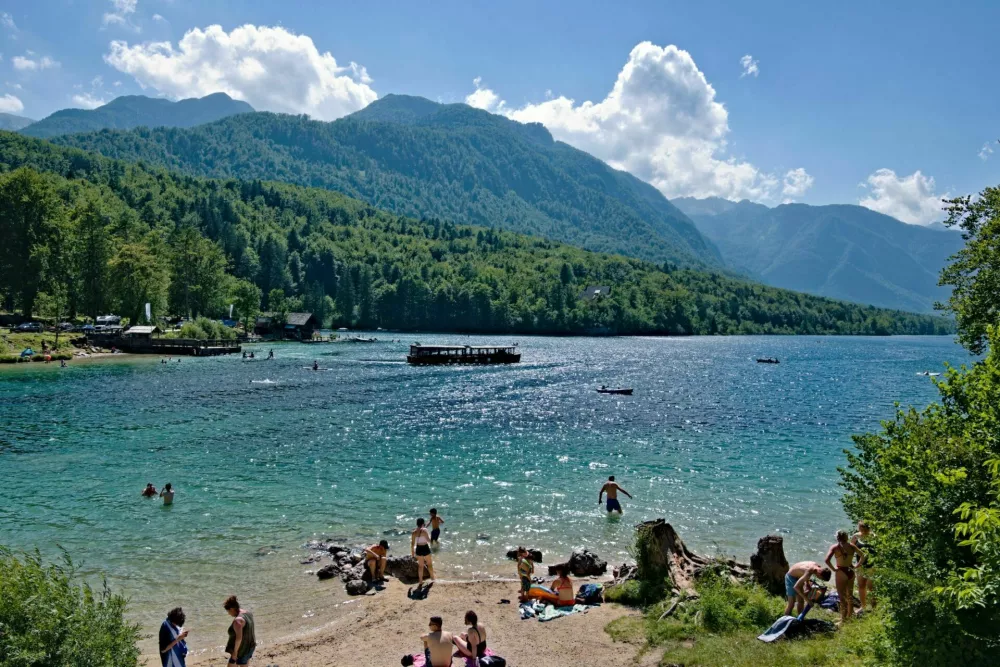 Stara Fuzina, Slovenia - July 16, 2023: People are enjoying summer sunny day on the beach. Very popular tourist destination.