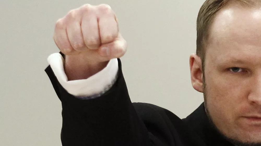 Norwegian mass killer Anders Behring Breivik clenches his fist in a far-right salute as he arrives in court for the second day of his terrorism and murder trial in Oslo April 17, 2012. Breivik, 33, has admitted setting off a car bomb that killed eight people at government headquarters in Oslo last July, then killing 69 in a shooting spree at a summer youth camp organised by the ruling Labour Party. The trial is scheduled to last 10 weeks, during which the court must rule on both his guilt, and his sanity.    REUTERS/Stoyan Nenov (NORWAY - Tags: CRIME LAW)