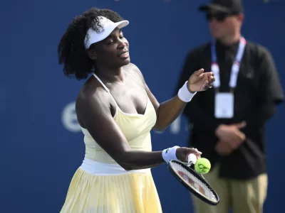 Venus Williams hits a ball toward the crowd after a doubles match with Hailey Baptiste against Eugenie Bouchard and Clervie Ngounoue at the Citi Open tennis tournament Monday, July 21, 2025, in Washington. (AP Photo/Nick Wass)