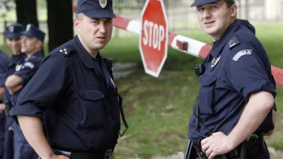 Police stand at the entrance of Serbia's special court while the verdict is read out in the trial of the murder of Serbian Prime Minister Zoran Djindjic in Belgrade May 23, 2007. Two former members of a Serbian paramilitary police unit and 10 co-conspirators were found guilty on Wednesday of the assassination of reformist Djindjic four years ago. REUTERS/Ivan Milutinovic (SERBIA)