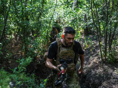 A service member of the 13th Operative Purpose Brigade 'Khartiia' of the National Guard of Ukraine walks at a position with a remote controller near a front line, amid Russia's attack on Ukraine, in Kharkiv region, Ukraine July 20, 2025. REUTERS/Serhii Korovainyi