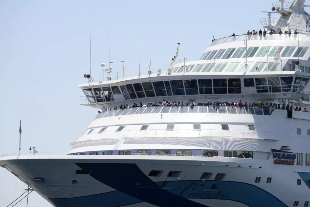 A cruise ship carrying Israeli tourists try to approach the Aegean Sea island of Syros, Greece, Tuesday, July 22, 2025. (Nikos Panagiotopoulos/InTime News via AP)